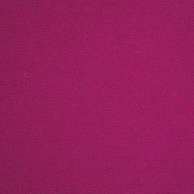 Close-up of saturated magenta textile with a softly mottled, low-sheen surface
