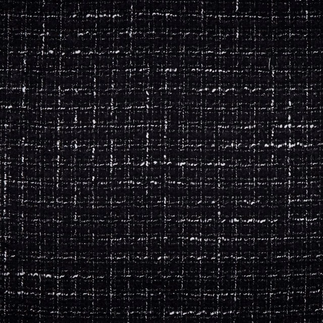 Near-black woven upholstery with irregular white flecks and crosshatch texture