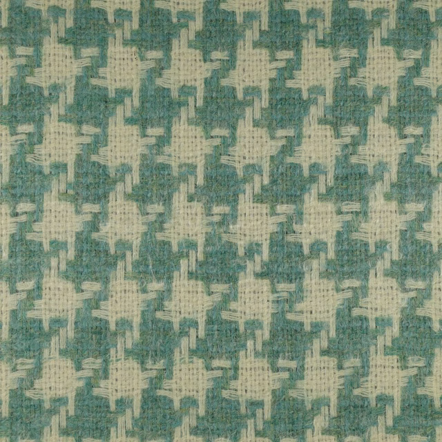 Muted teal fabric with ivory cross-like motifs and a nubby woven texture