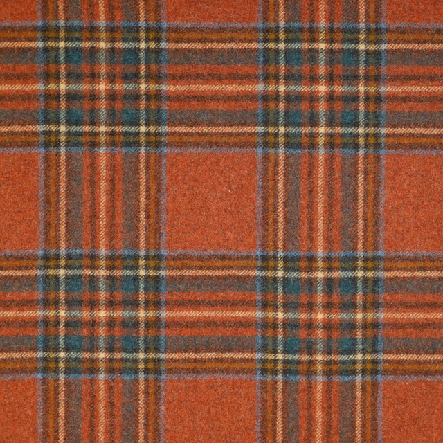 Rust terracotta tartan with teal, ochre and charcoal woven stripes and soft texture