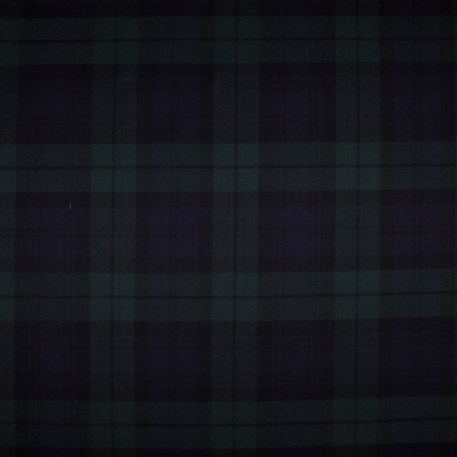 Deep green and black tartan checks in a subtly textured dark weave