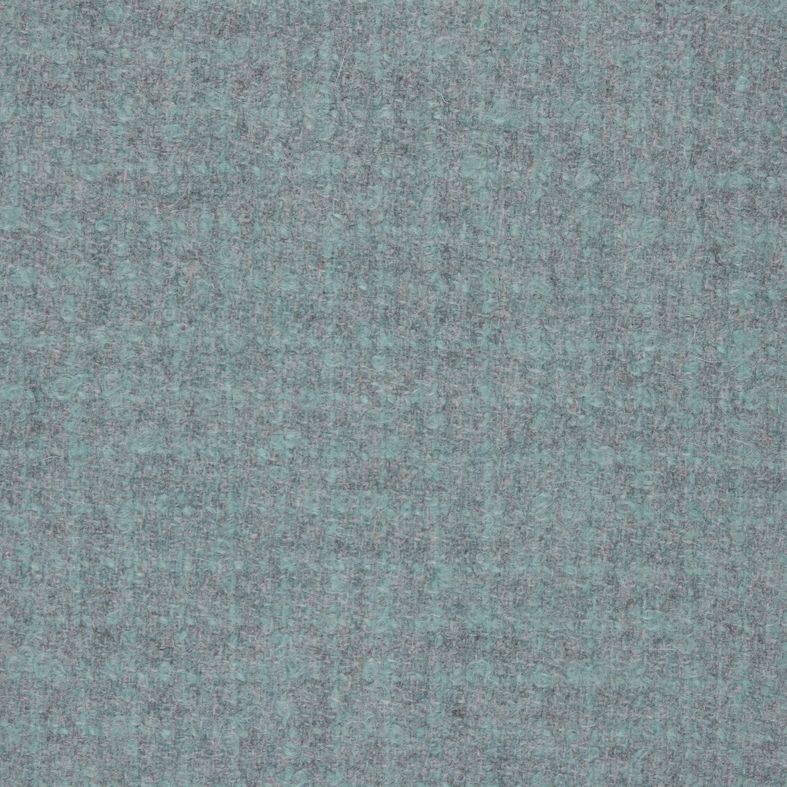 Close-up of cool slate-grey bouclé with blue-green flecks and mottled texture