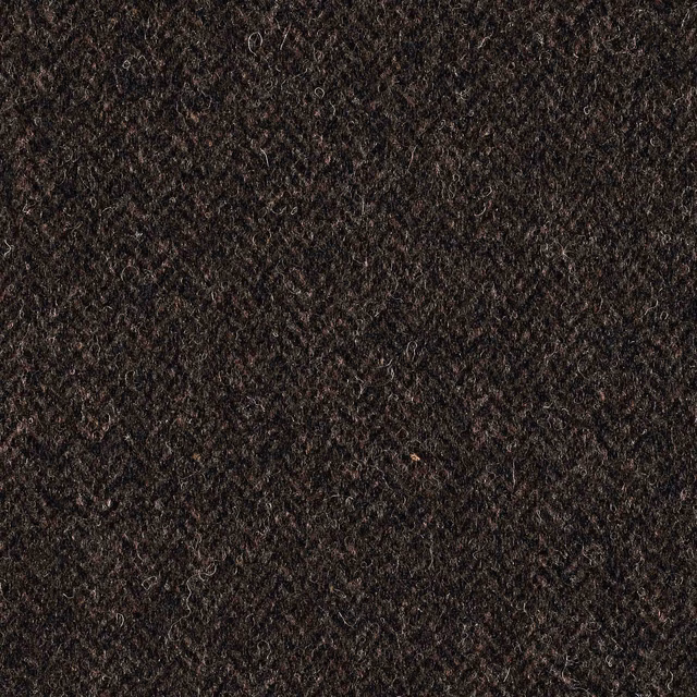 Close-up of dense brown-black textile with curled fibres and subtle mottled highlights
