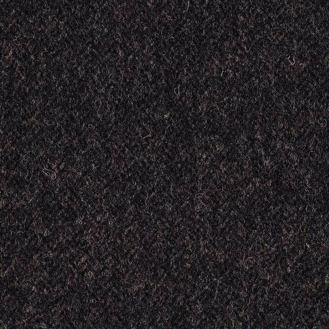 Close-up of dense charcoal curls with subtle grey and brown flecks
