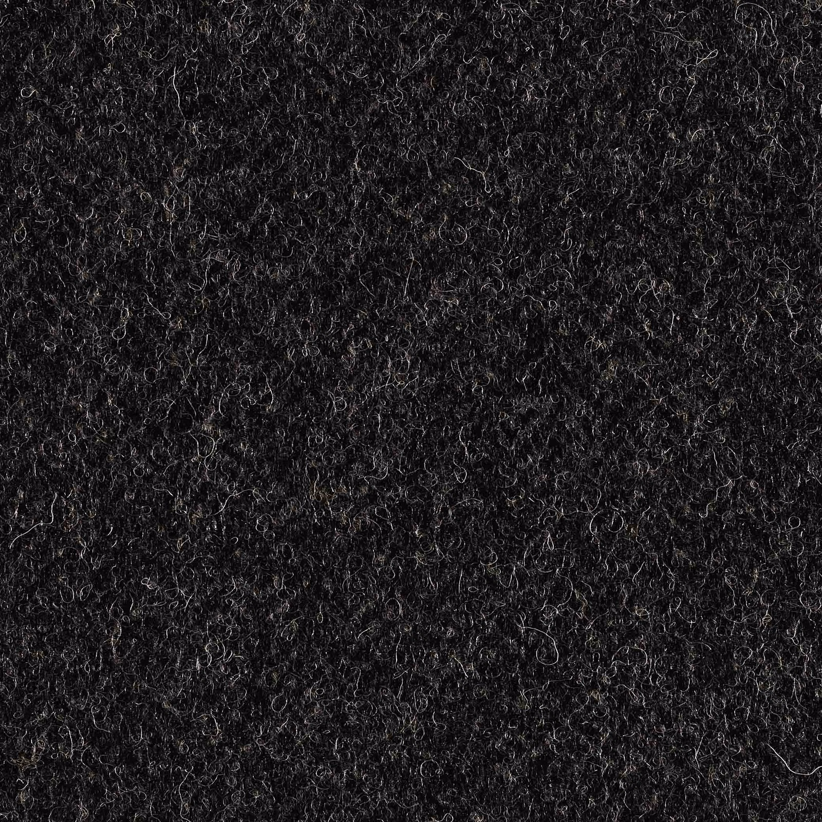 Close-up of dark charcoal grey fabric with dense curly fibres and subtle lighter strands