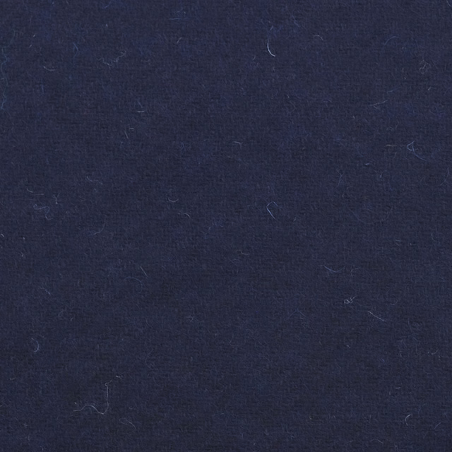 Deep navy woven surface with faint horizontal texture and a few loose fibres