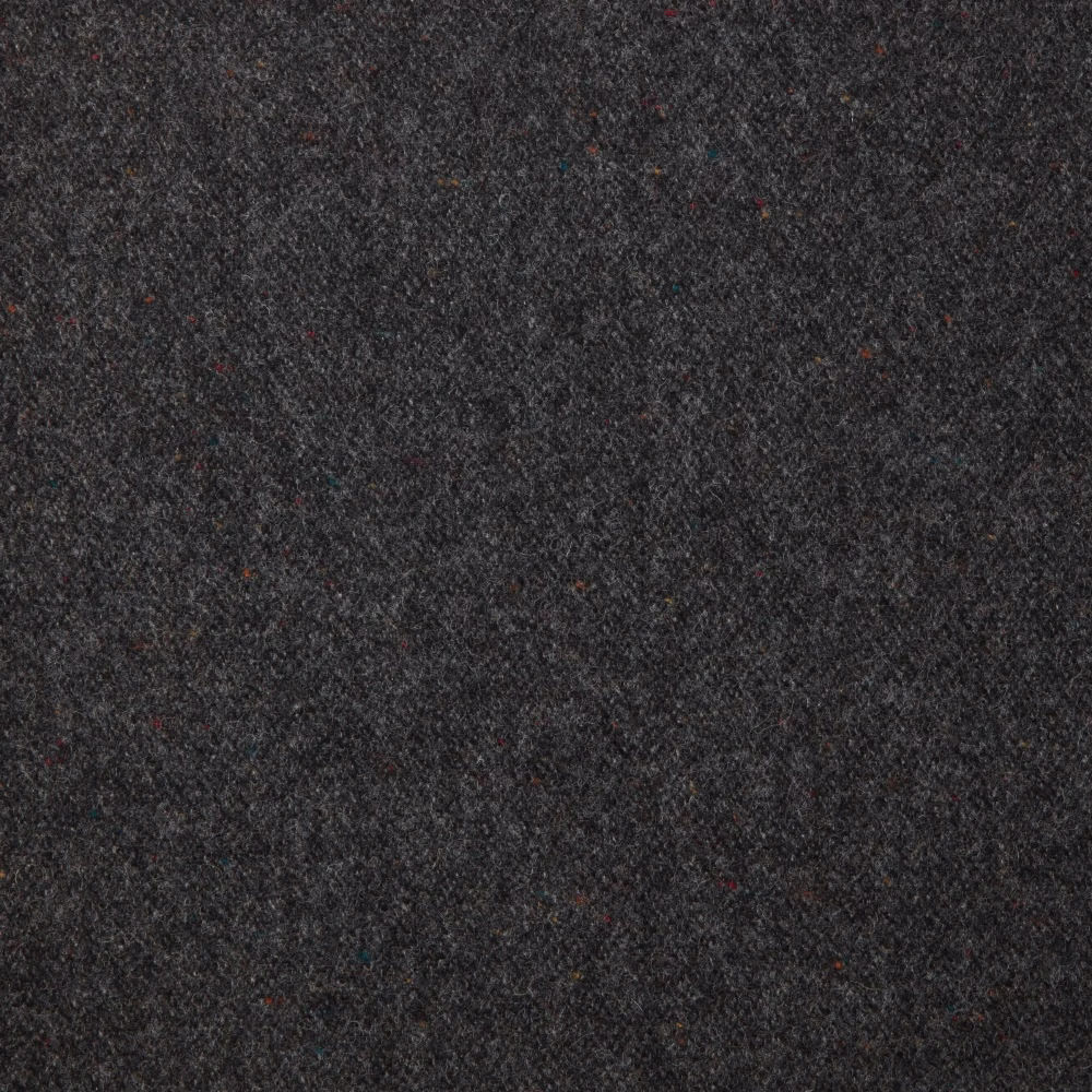 Close-up of dark charcoal fabric with dense mottled weave and subtle coloured flecks