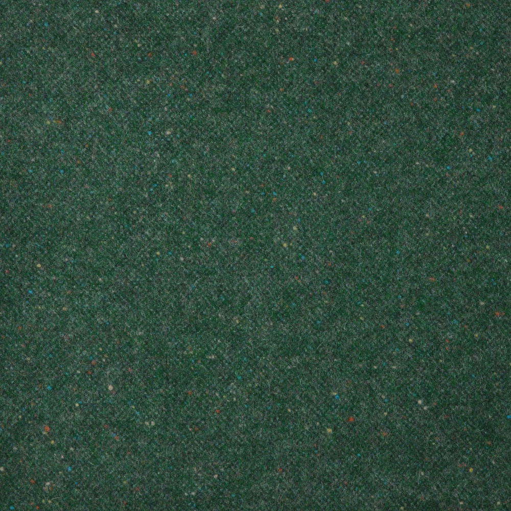 Close-up of dense emerald green weave with subtle teal, brown and red flecks