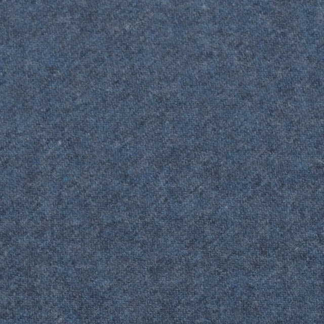 Close-up of dusty blue-grey fabric with a fine, mottled woven texture