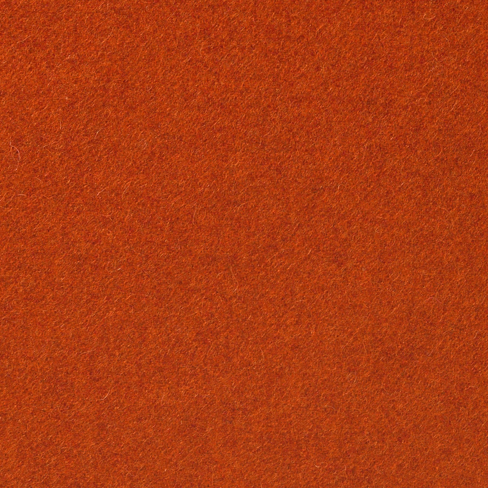 Close-up of burnt terracotta-orange fabric with a softly mottled brushed texture
