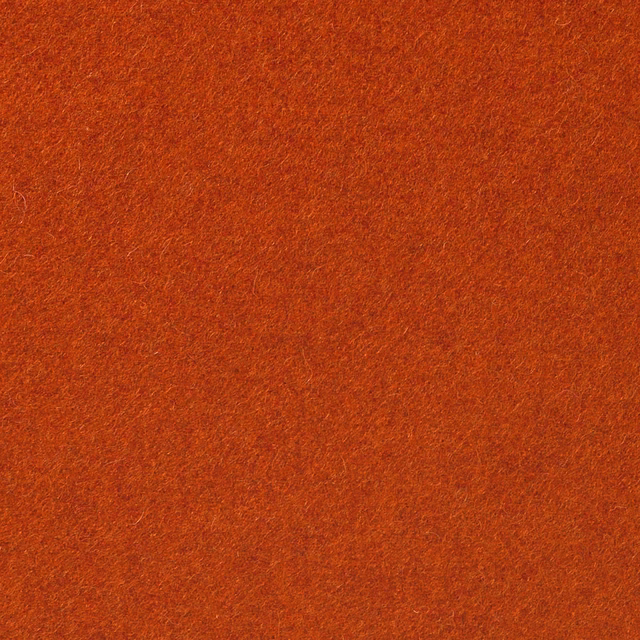 Close-up of burnt terracotta-orange fabric with a softly mottled brushed texture