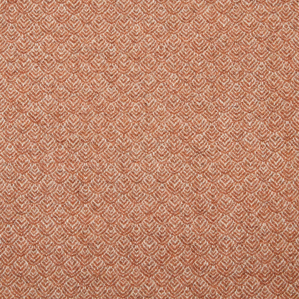 Warm terracotta textile with tiny cream chevron motifs and a tactile woven surface