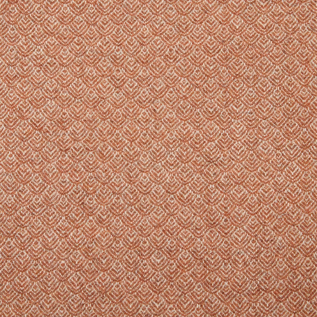 Warm terracotta textile with tiny cream chevron motifs and a tactile woven surface