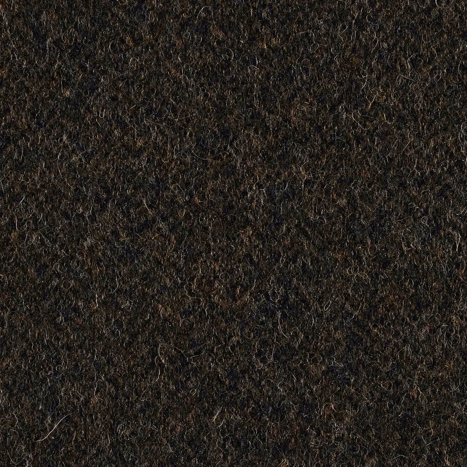 Near-black forest green fabric with brown flecks and dense nubby fibres