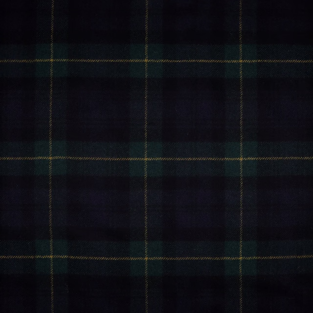 Close-up of dark navy-black check fabric with forest green blocks and fine ochre lines