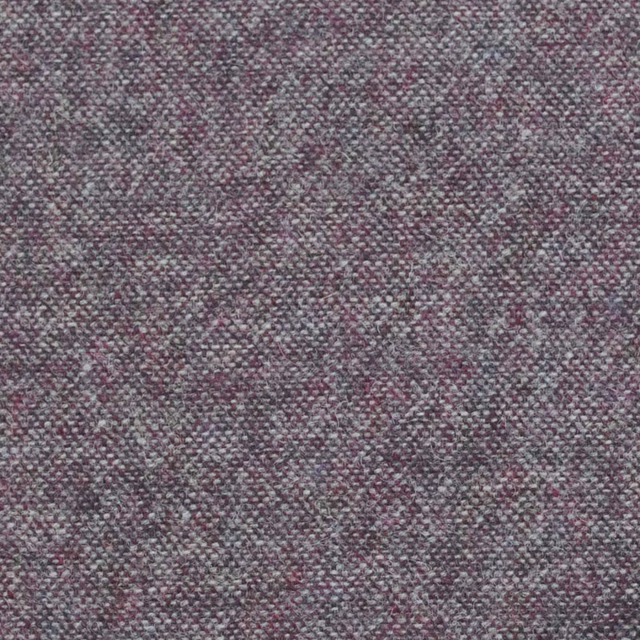 Close-up of muted grape-grey fabric with fine mottled weave and plum flecks