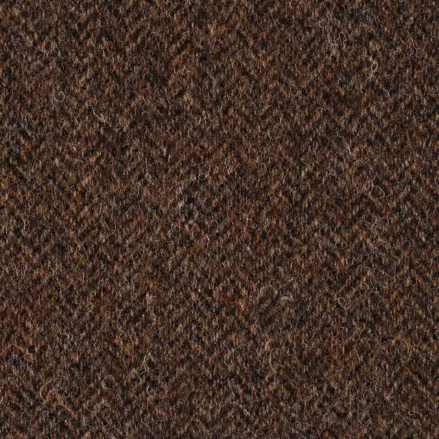 Deep brown fabric with dense irregular loops and warm coppery fibre highlights