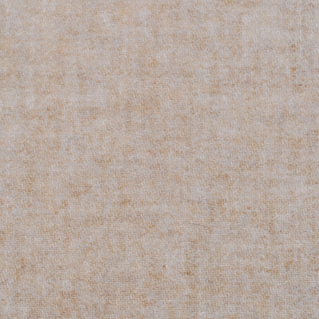 Warm oatmeal woven textile with softly mottled fine texture in close-up
