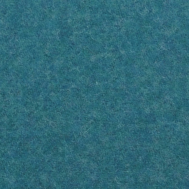 Close-up of deep mottled teal fabric with a fine, softly fibrous woven texture
