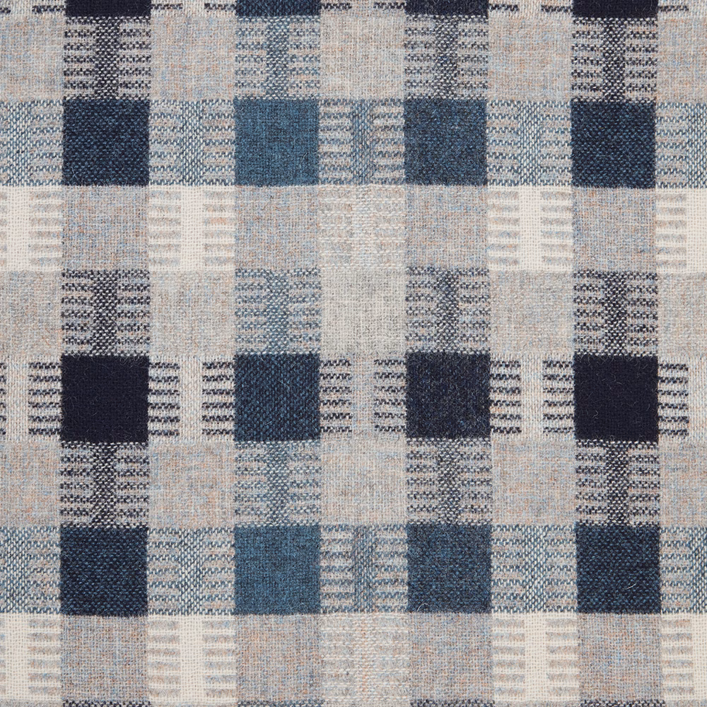 Denim-blue geometric blocks with navy squares in a flecked woven textile
