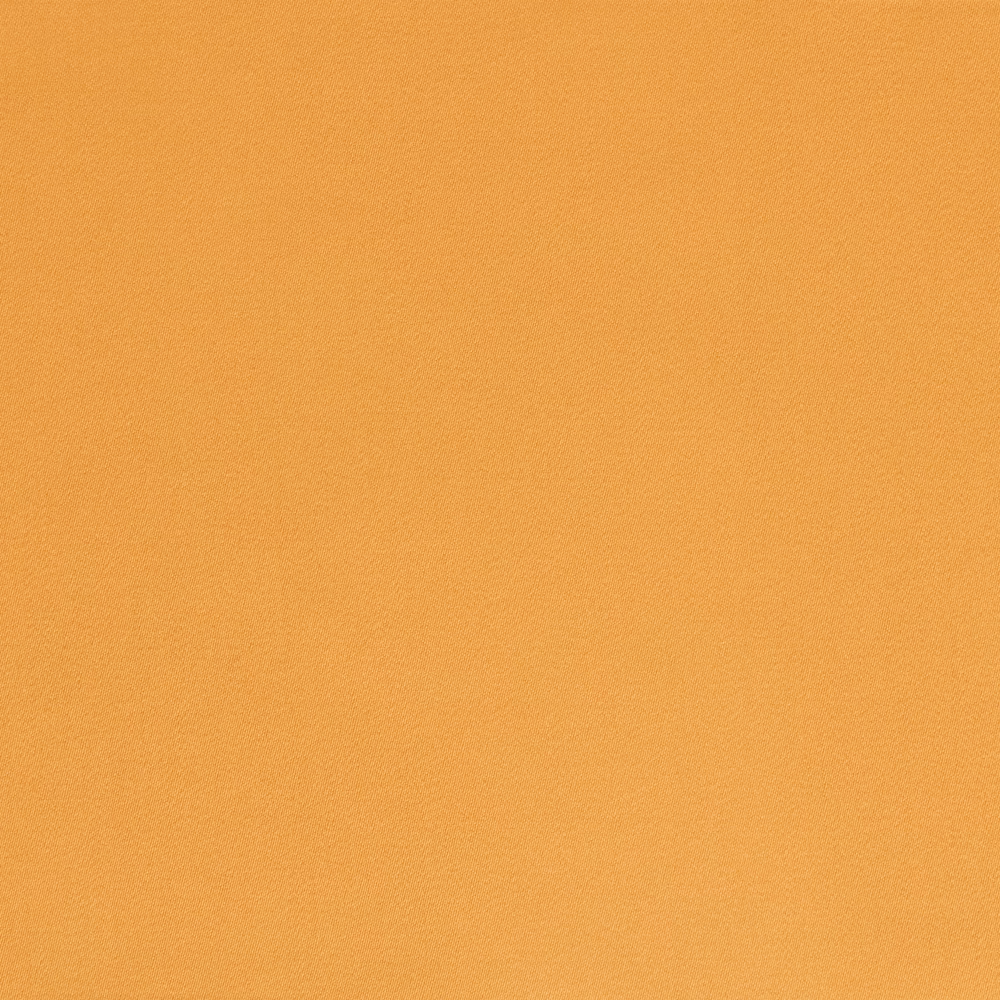 Close-up of plain ochre-gold satin with a fine texture and soft sheen