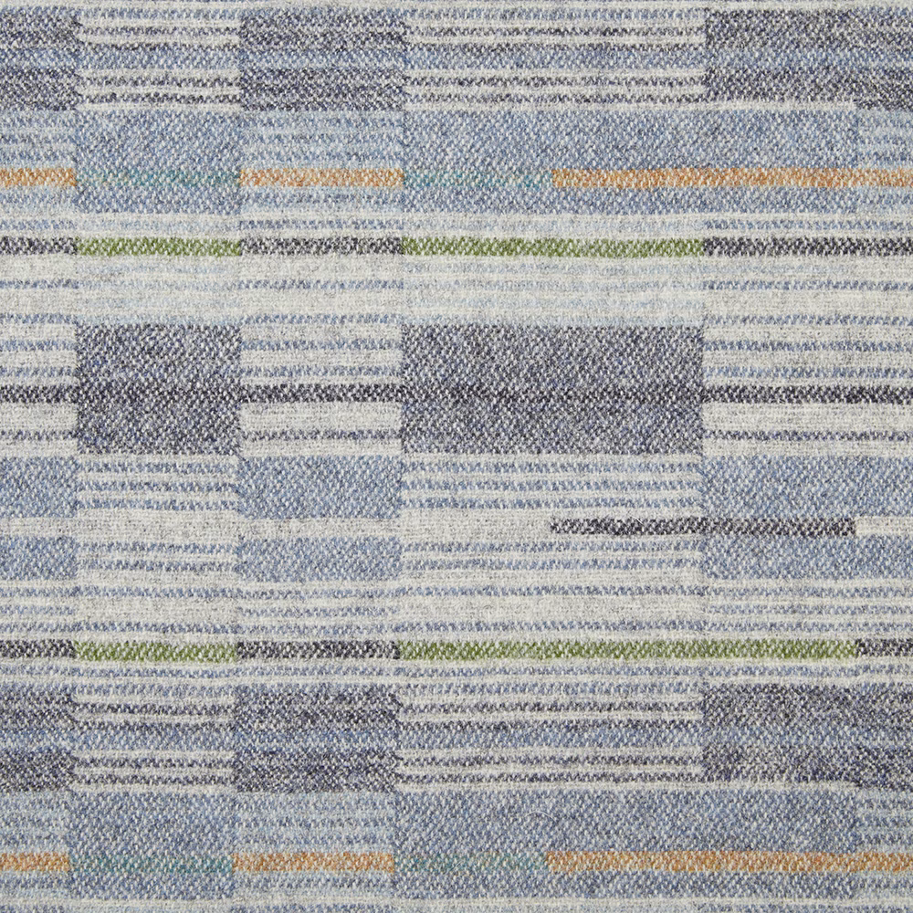 Close-up of denim-blue woven blocks with pale grey, green and ochre bands