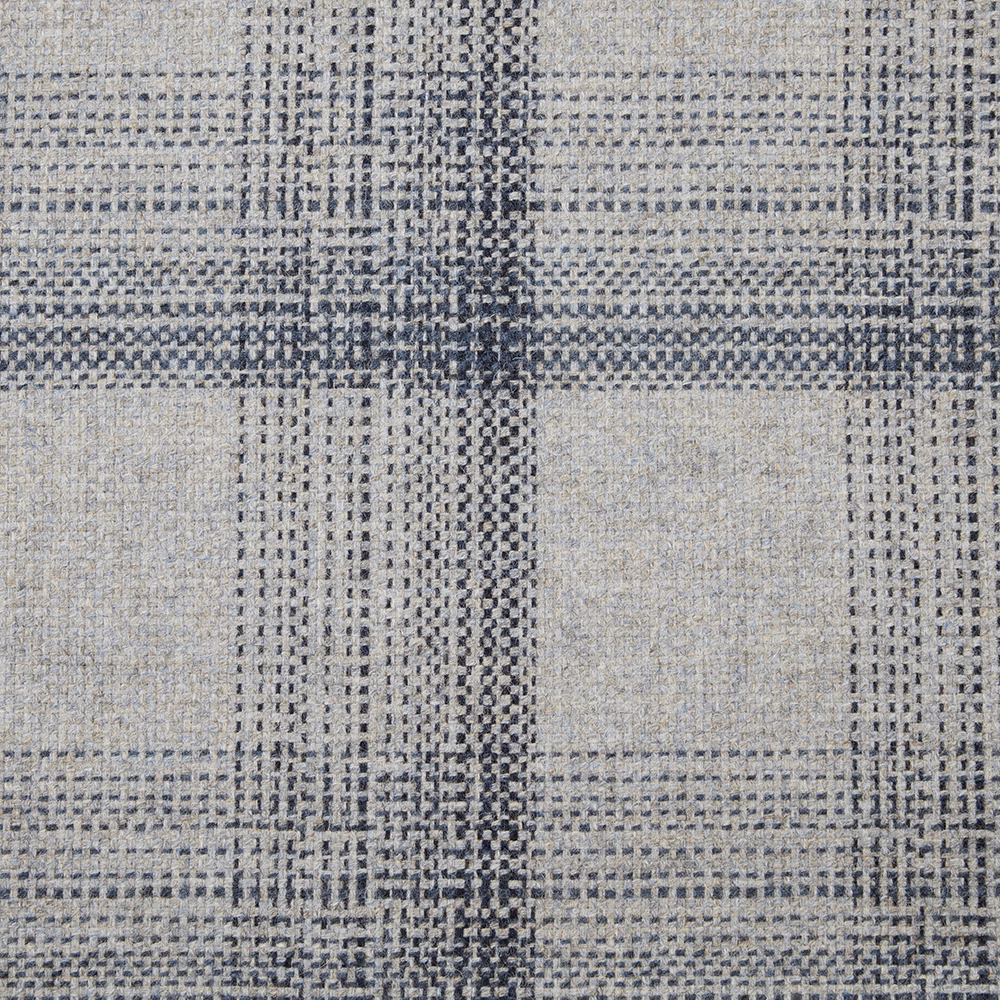 Muted denim blue woven textile with irregular charcoal grid and tactile pale-grey texture