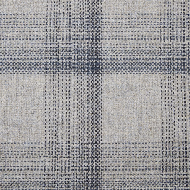 Muted denim blue woven textile with irregular charcoal grid and tactile pale-grey texture