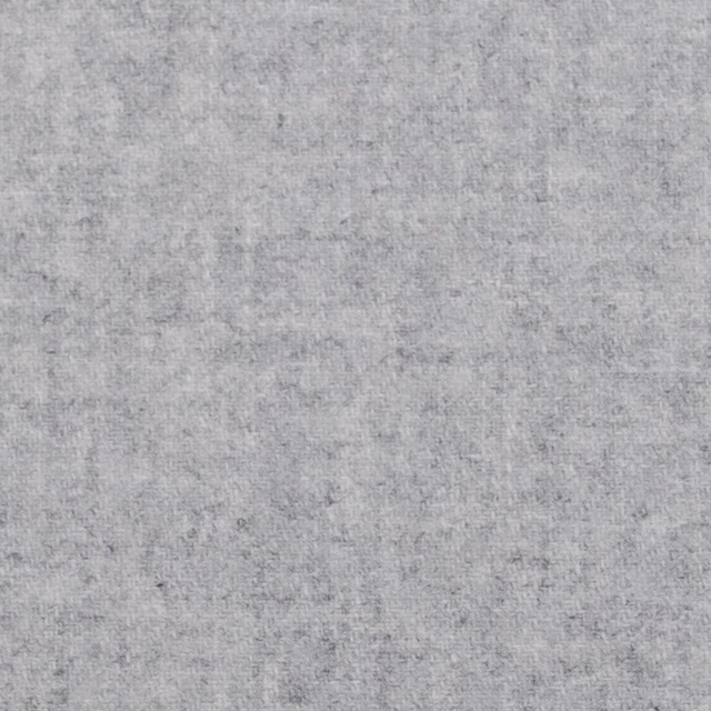 Close-up of pale silver grey fabric with a fine cloudy marl and softly uneven texture