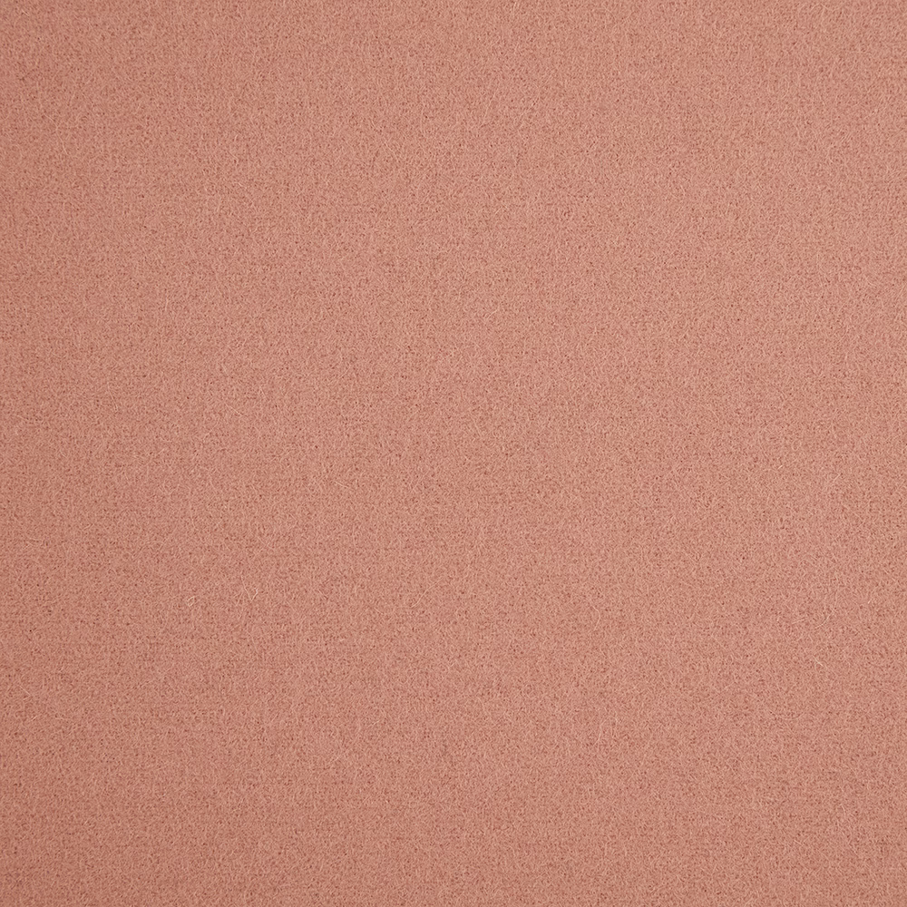 Muted dusky pink fabric with a fine, even granular surface texture