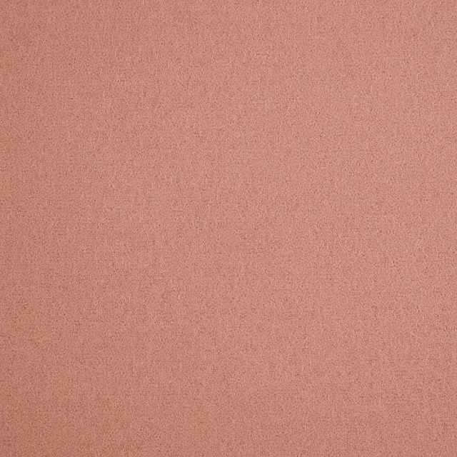Muted dusky pink fabric with a fine, even granular surface texture