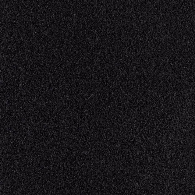Close-up of deep black fabric with a dense, softly raised textured surface