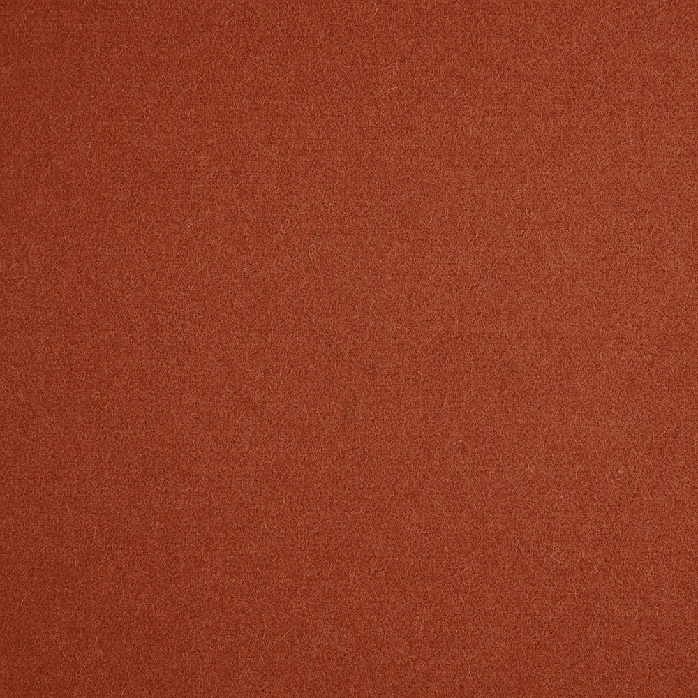 Close-up of warm terracotta fabric with a subtly mottled, fine woven texture