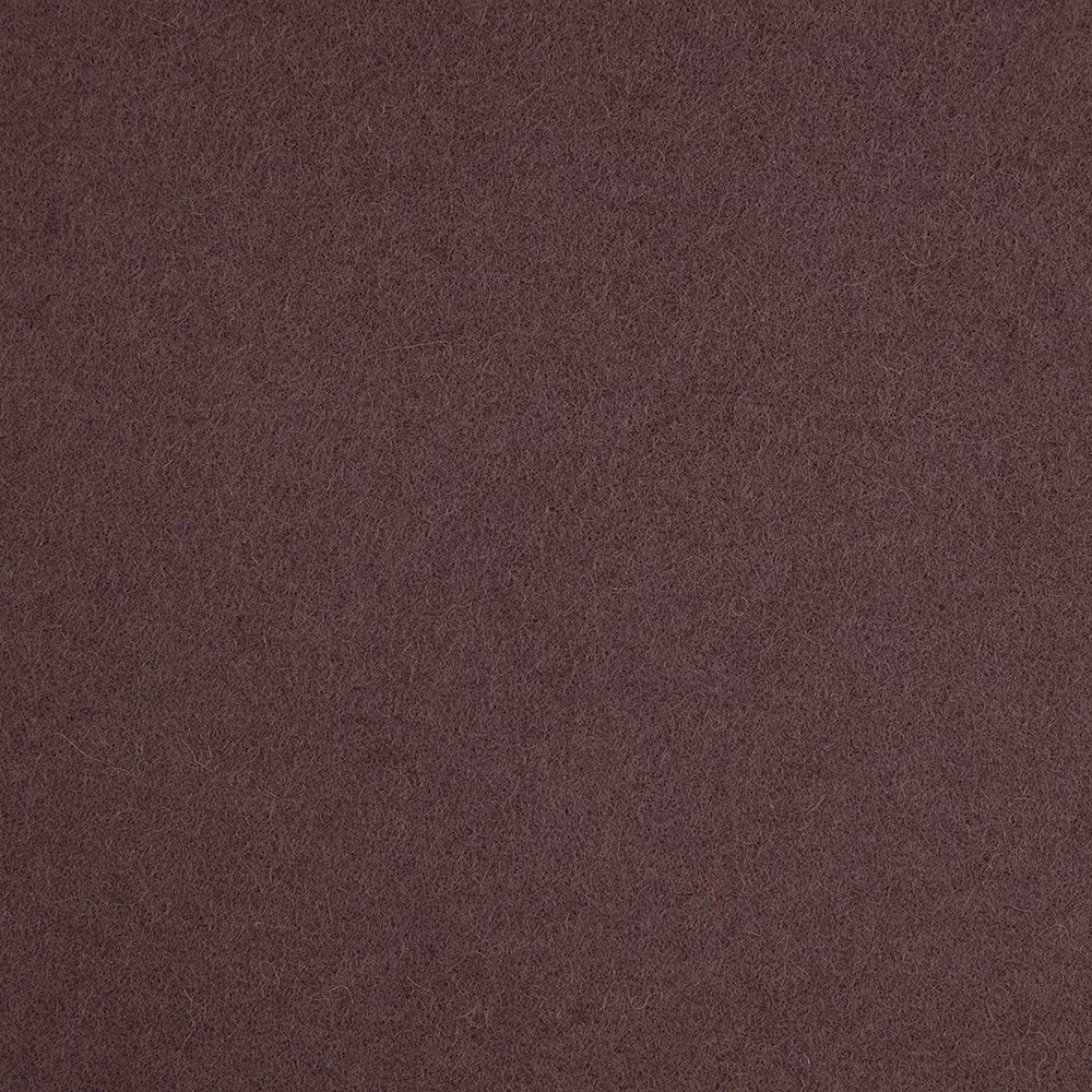 Close-up of dense muted plum fabric with a subtly mottled, softly textured surface