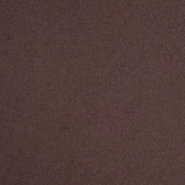 Close-up of dense muted plum fabric with a subtly mottled, softly textured surface