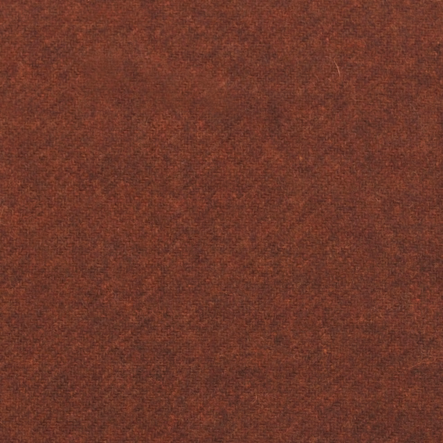 Close-up of warm spice-brown fabric with fine, subtly mottled woven texture