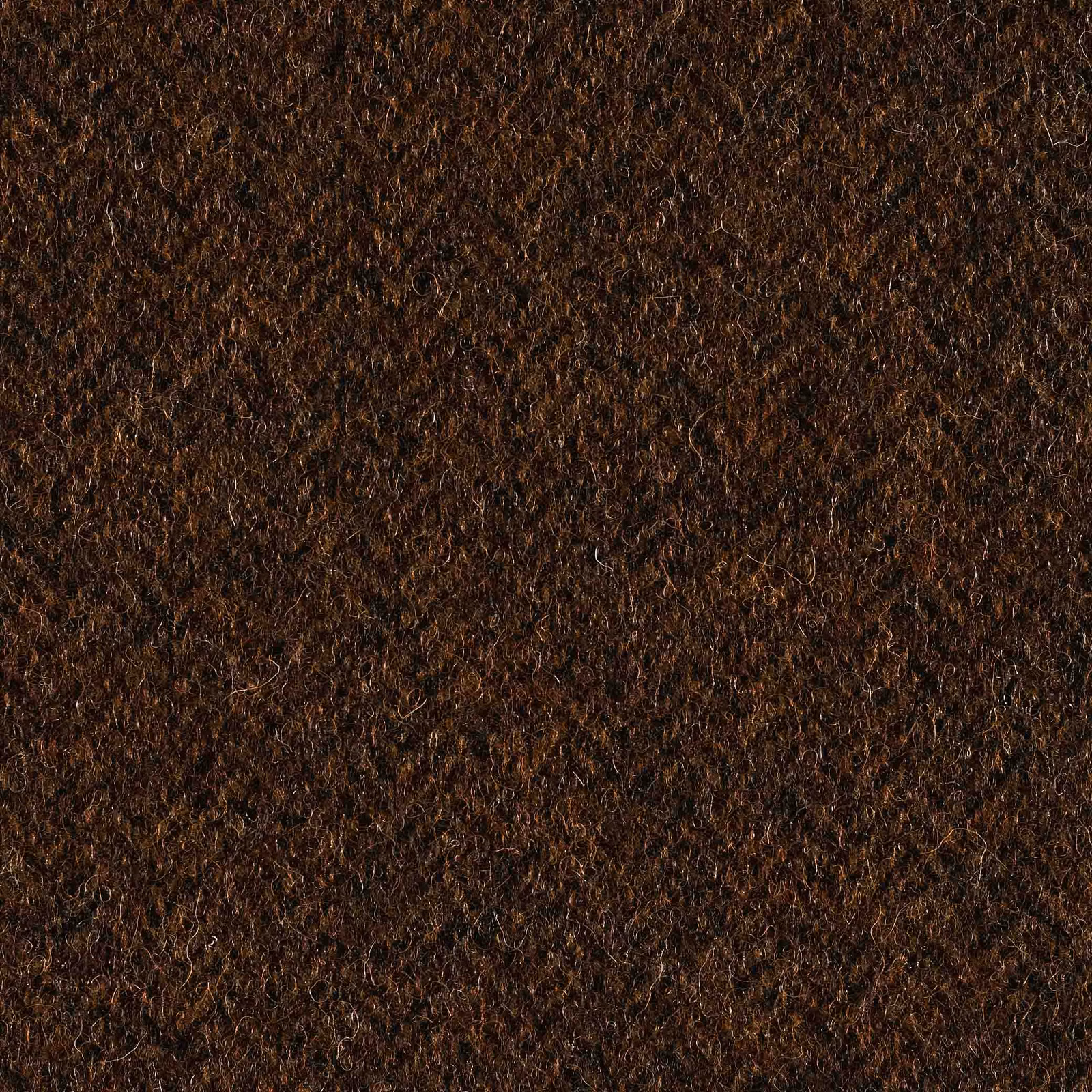 Close-up of dense, curly tobacco-brown textile with black, russet and umber flecks