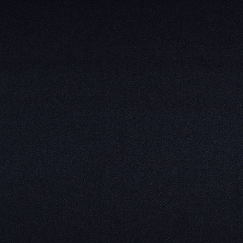 Close-up of blue-black charcoal fabric with a fine, subtly textured plain weave