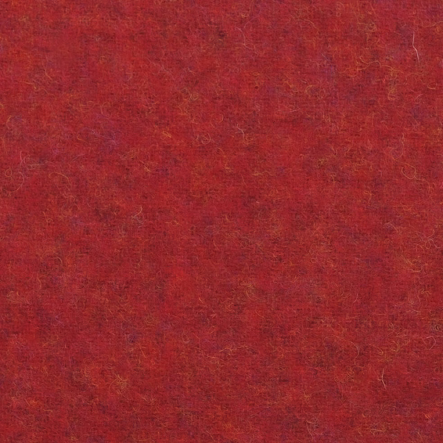 Warm red textile with mottled shading, fine golden flecks and softly fibrous texture