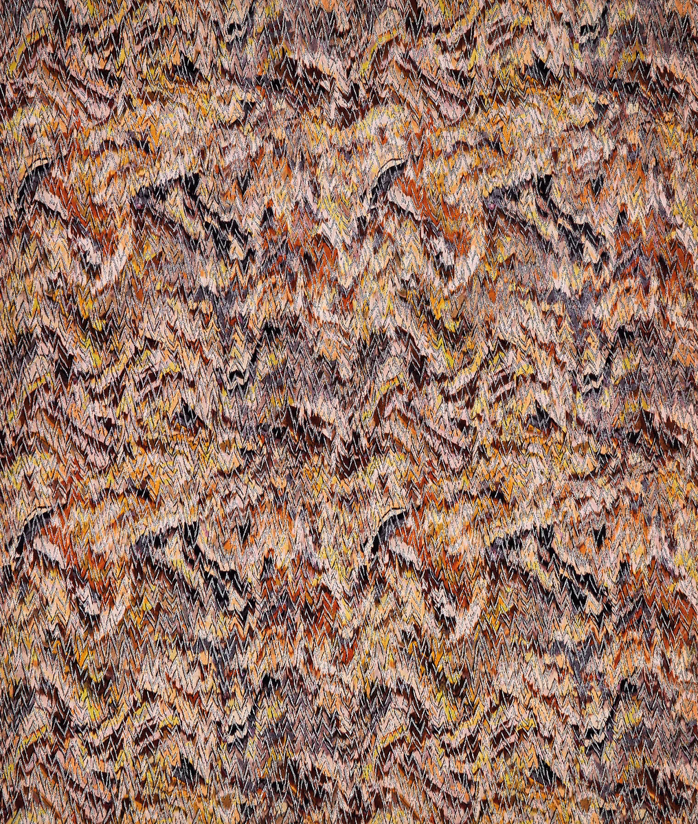 Close-up of zigzag woven fabric in rust, ochre, taupe and black
