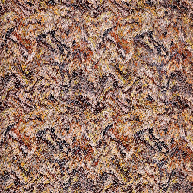 Close-up of zigzag woven fabric in rust, ochre, taupe and black