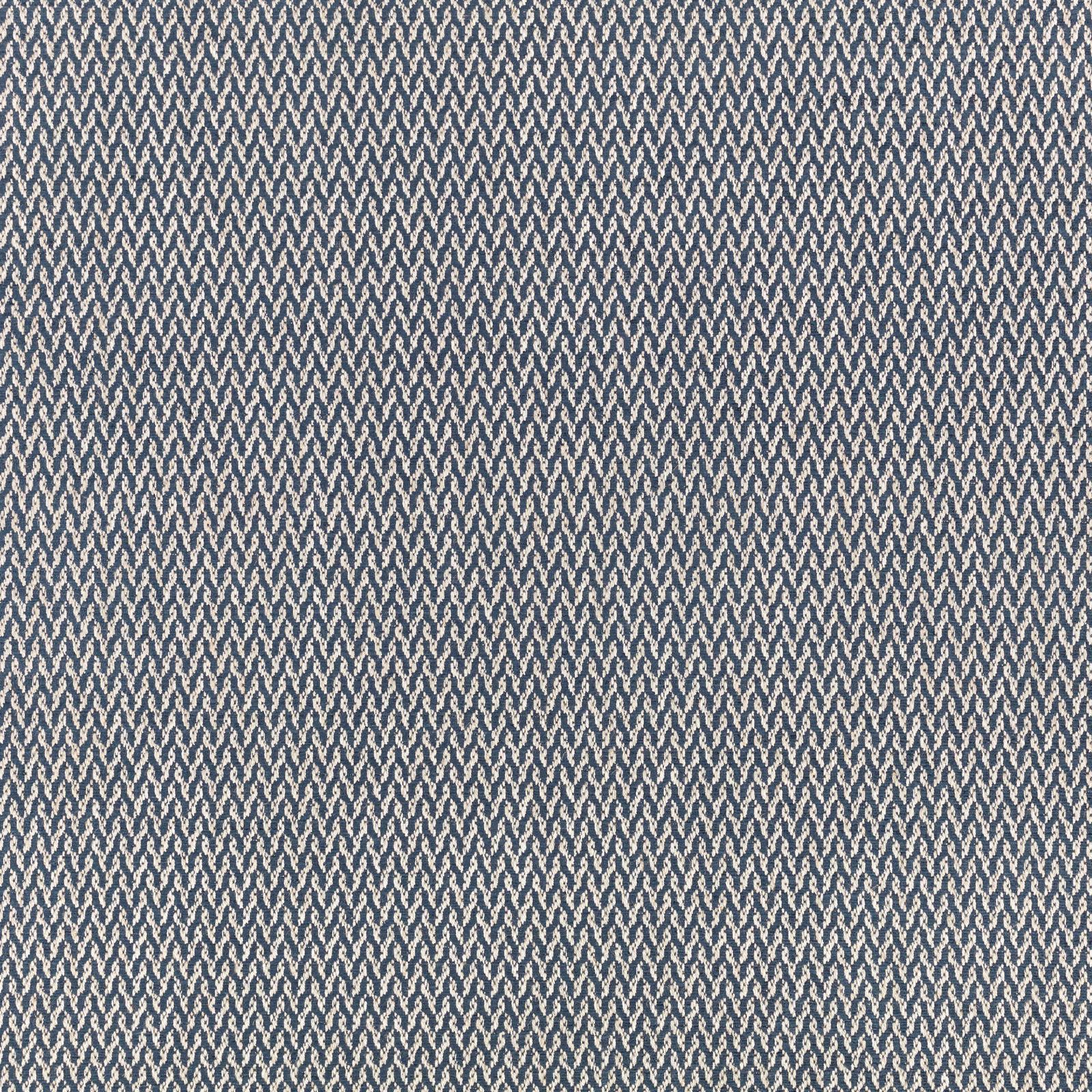 Cool blue-grey woven ground with tiny repeating zigzag motifs in close view