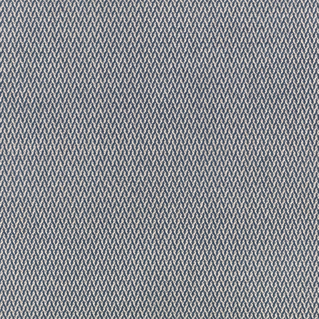 Cool blue-grey woven ground with tiny repeating zigzag motifs in close view