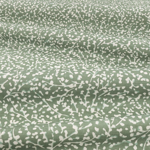 Dill-green and ivory abstract branching pattern across a softly folded fabric swatch