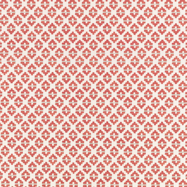 Small coral-red geometric motifs repeat across a warm ivory woven ground