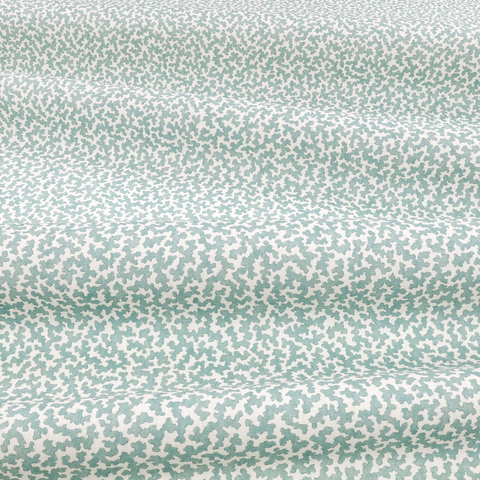Pale aqua-teal fabric with dense irregular flecks across softly folded cloth