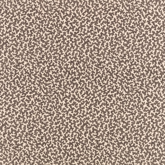 Warm beige fabric with dense irregular taupe-brown stippled pattern