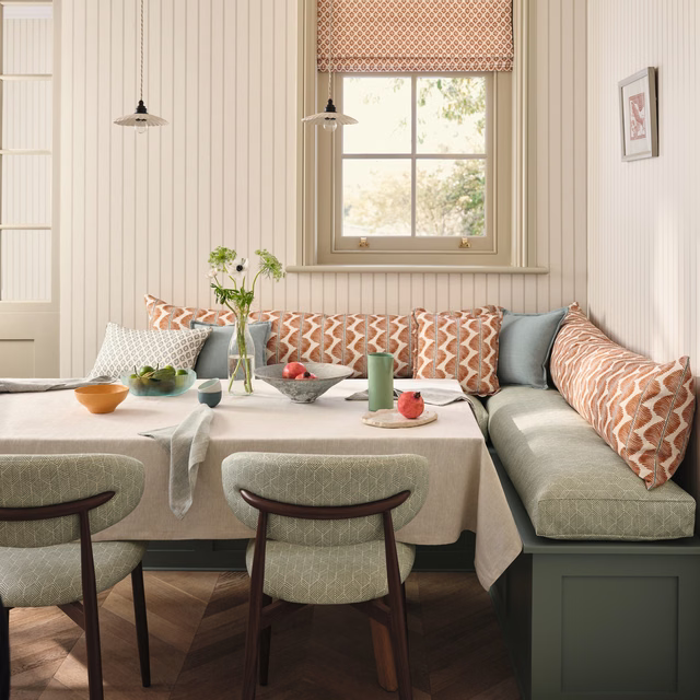 Cream, rust and sage geometric zigzag textile on cushions and Roman blind