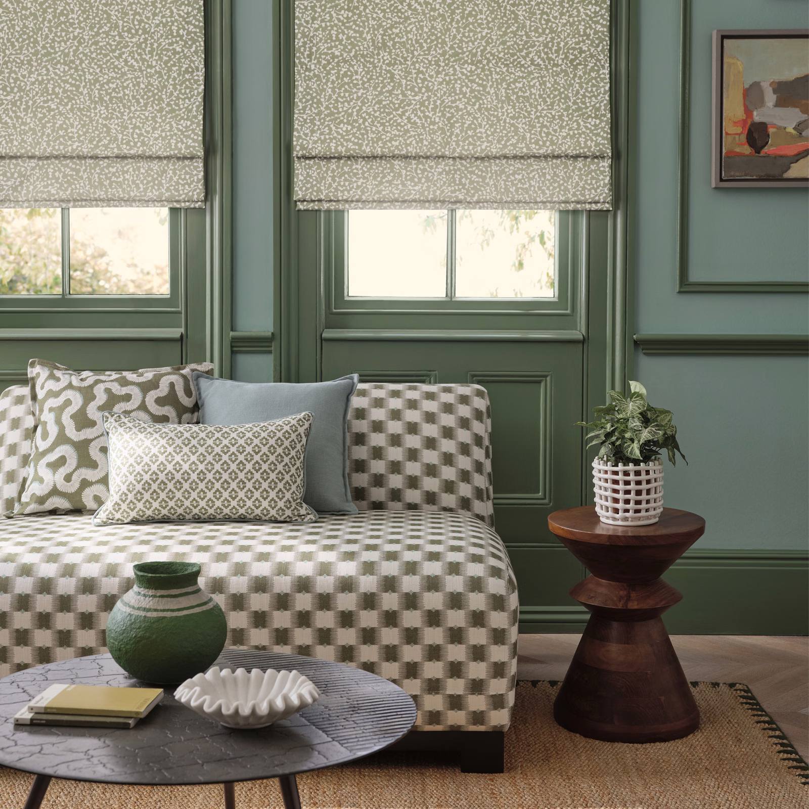 Muted sage-green fabric with a dense pale fleck pattern on a Roman blind
