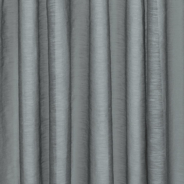 Muted French blue-grey textile with fine slub texture falling in softly shaded vertical folds